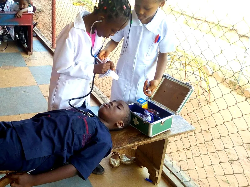 Pupils acting out a medical check-up during Career Day, learning by doing