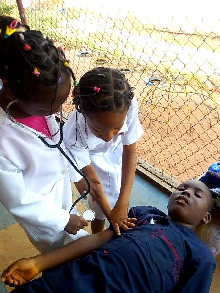 Two pupils playing doctor and patient during Career Day
