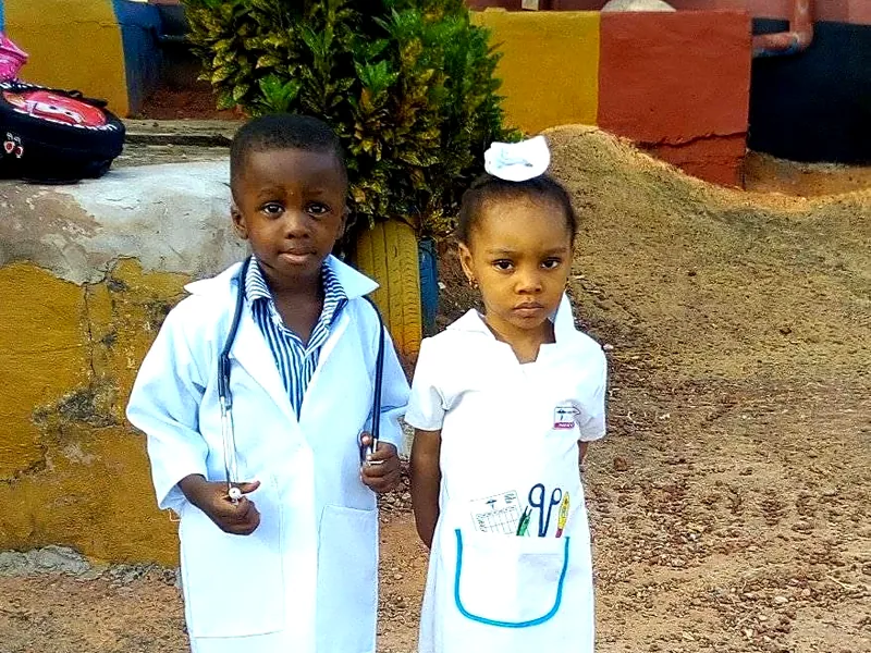 Two Sure Edge pupils dressed as a doctor and a nurse on Career Day