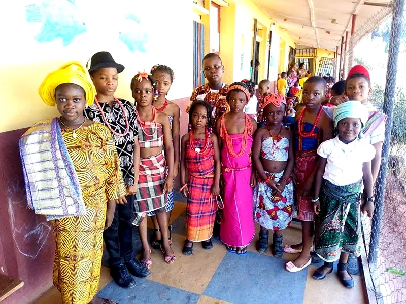 Pupils in traditional dress along the school corridor