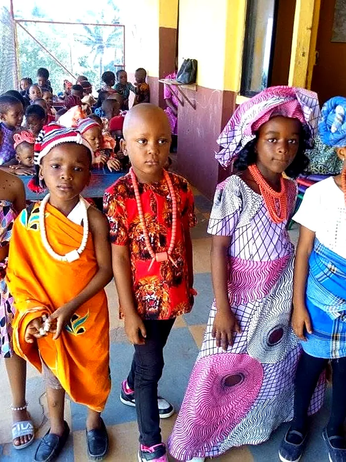 Pupils in colourful traditional dress lined up for Cultural Day
