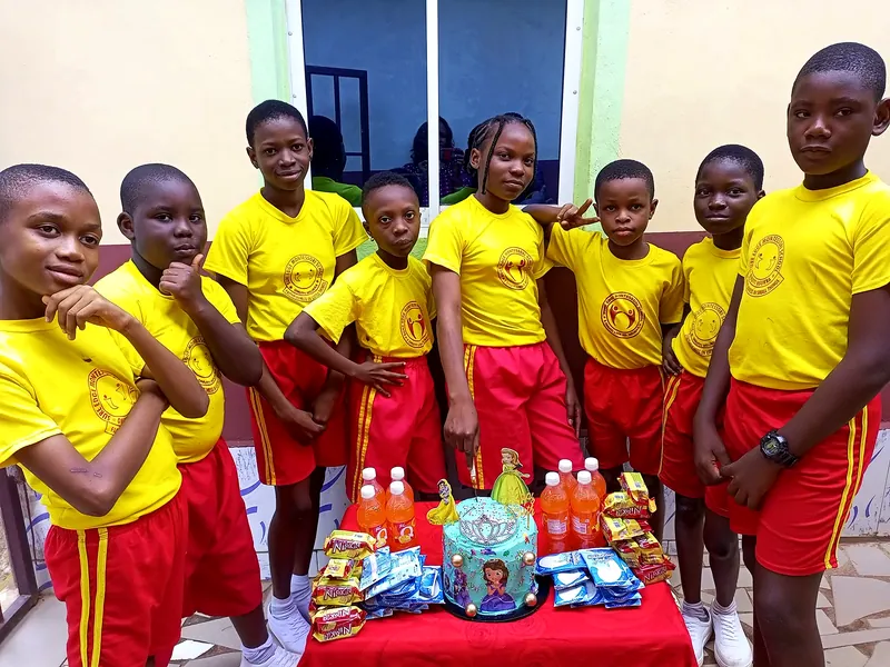 Sure Edge students together in the school’s yellow and red kit